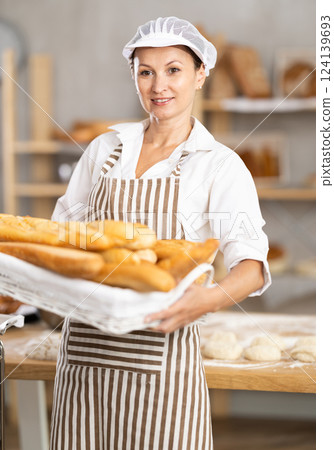 Portrait of positive woman bakery worker Portrait of positive woman bakery worker 124139693