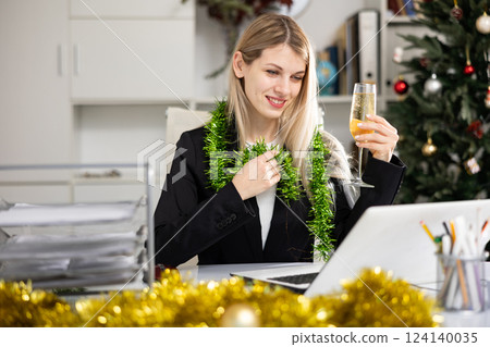 Woman bookkeeper wishing happy New Year to someone via video call Woman bookkeeper wishing happy New Year to someone via video call 124140035