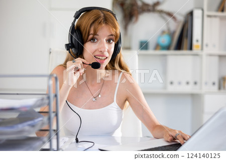 Attractive young woman working in call center Attractive young woman working in call center 124140125