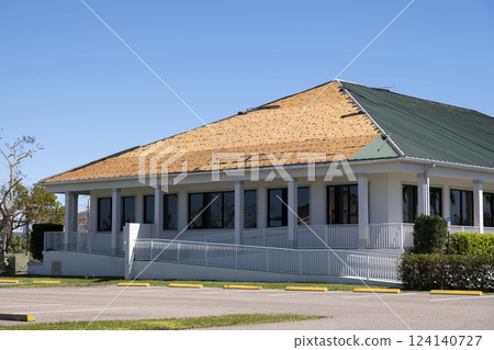 Hurricane Ian destroyed house roof in Florida residential area. Natural disaster and its consequences 124140727