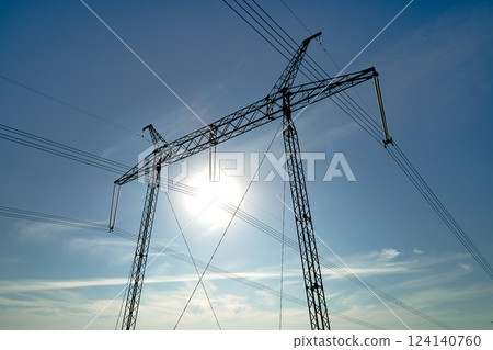 High voltage tower with electric power lines transfening electrical energy through cable wires High voltage tower with electric power lines transfening electrical energy through cable wires 124140760