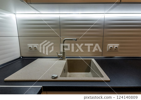 Granite sink and water faucet in new modern kitchen interior Granite sink and water faucet in new modern kitchen interior 124140809