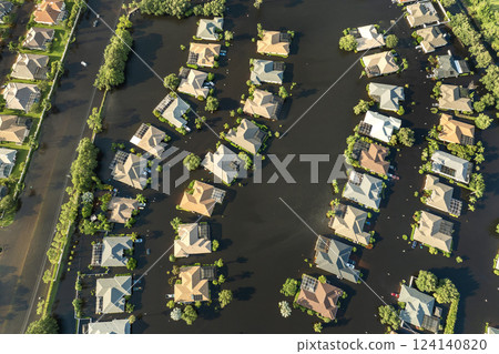 Flooding in Florida caused by tropical storm from hurricane rainfall. Suburb houses in residential community surrounded by flood waters. Aftermath of natural disaster Flooding in Florida caused by tropical storm from hurricane rainfall. Suburb houses in residential community surrounded by flood waters. Aftermath of natural disaster 124140820