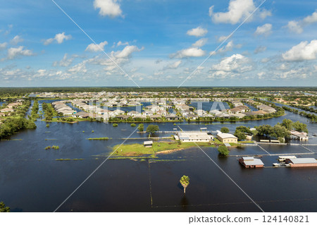 Flooding in Florida caused by tropical storm from hurricane rainfall. Farm houses in rural area surrounded by flood waters. Aftermath of natural disaster 124140821