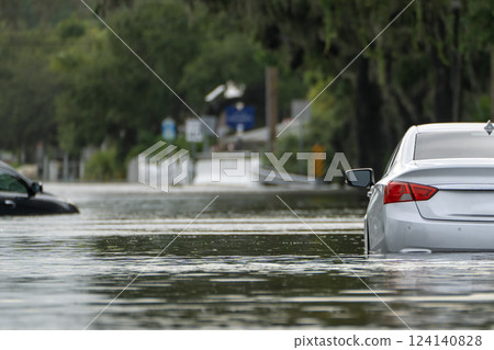 Flooded road with sunken cars in surrounded with water Florida residential area. Consequences of hurricane Debby natural disaster Flooded road with sunken cars in surrounded with water Florida residential area. Consequences of hurricane Debby natural disaster 124140828