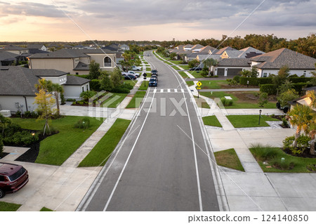 Expensive mansions between green palm trees in southwest Florida suburbs, USA. Aerial view of wealthy residential neighborhood Expensive mansions between green palm trees in southwest Florida suburbs, USA. Aerial view of wealthy residential neighborhood 124140850