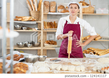 Adult female baker with rolling pin 124141117