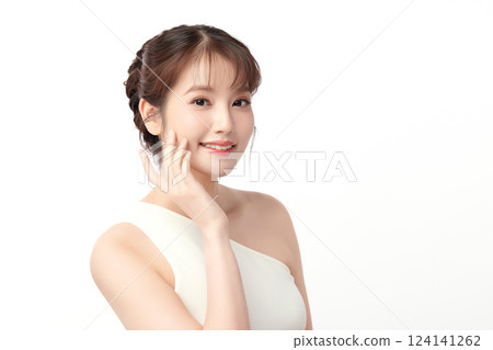 A beautiful young Asian woman with clean, fresh skin against a white background. Skincare, facial treatment, cosmetology, beauty, and spa. An elegant portrait of an Asian woman. 124141262