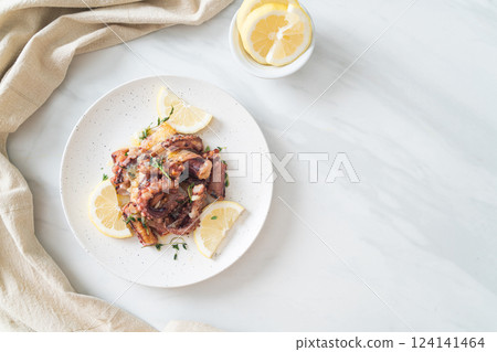 grilled octopus or squid with butter lemon sauce 124141464
