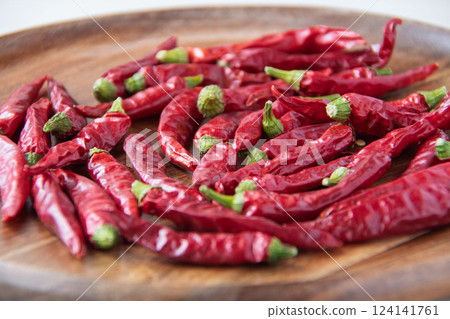 Red chili peppers on a wooden plate 124141761