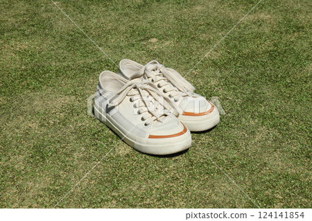 Sneakers on green grass, tennis sport concept. 124141854