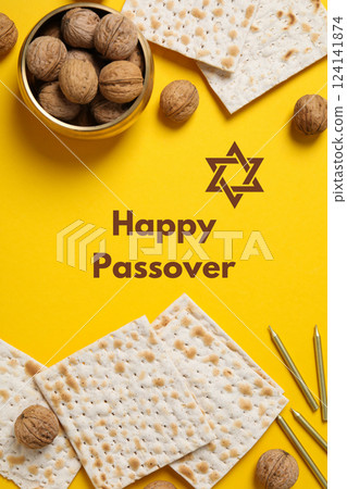 Passover, nuts and matzah with candles, with greeting text, on a yellow background 124141874