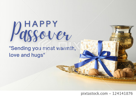 Passover, matzah with a bowl, nuts and greeting text, on a light background 124141876
