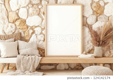 Cozy living room with neutral decor and empty frame on rustic stone wall in stylish home interior design 124142174