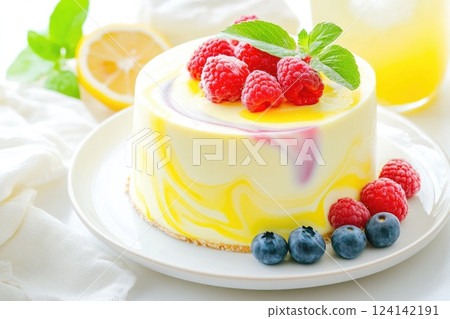 Delicious cheesecake topped with fresh raspberries and blueberries on a white plate Delicious cheesecake topped with fresh raspberries and blueberries on a white plate 124142191