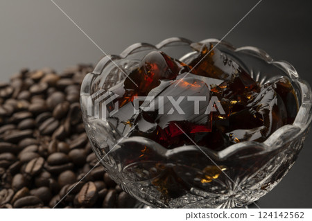 Cold coffee jelly and coffee beans served in a glass bowl Black background 124142562
