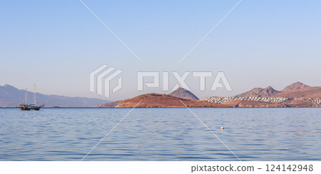 Blue sea, boats, islands and mountains. Calm seascape and coastal nature. Vacation concept 124142948