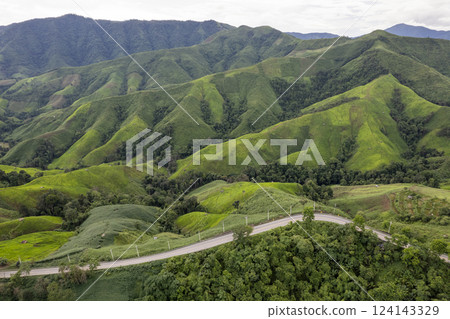 Landscape of Morning Mist with Mountain Layer. mountain ridge and clouds in rural jungle bush forest 124143329