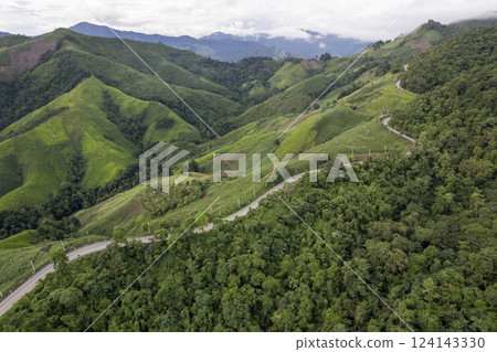 Landscape of Morning Mist with Mountain Layer. mountain ridge and clouds in rural jungle bush forest 124143330