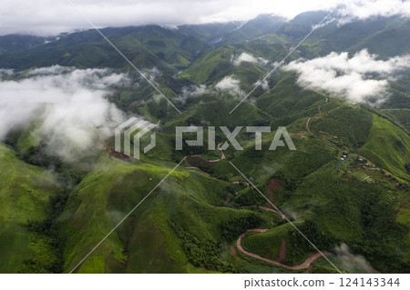 Landscape of Morning Mist with Mountain Layer. mountain ridge and clouds in rural jungle bush forest 124143344