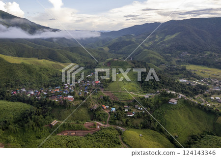 Landscape of Morning Mist with Mountain Layer. mountain ridge and clouds in rural jungle bush forest 124143346