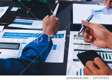 Business Team Analyzing Financial Data in Modern Office 124143831