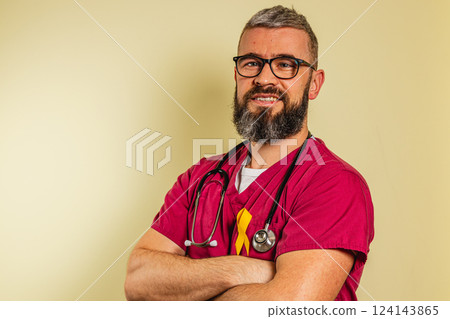 Happy male cardiologist in scrubs smiling confidently in a clinic 124143865