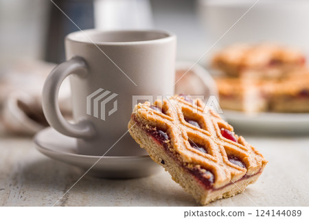 Sweet linzer cake and coffee cup on kitchen table. 124144089