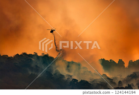 Fire fighting helicopter carry water bucket to extinguish the forest fire. 124144194