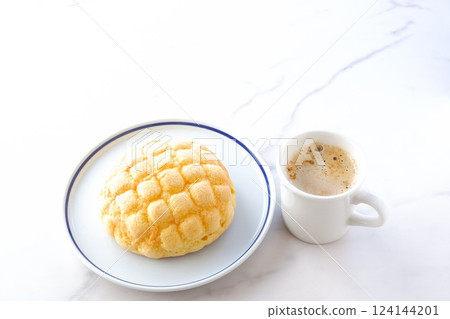 It's snack time with delicious melon bread and freshly brewed coffee (caffe latte). It's snack time with delicious melon bread and freshly brewed coffee (caffe latte). 124144201