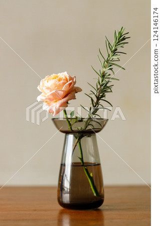 Beautiful pinkish coral orange roses under sunlight in on wooden table. Floral natural background with rose flower. 124146174