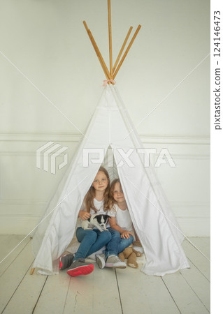 Little child girl with dog pet at home 124146473