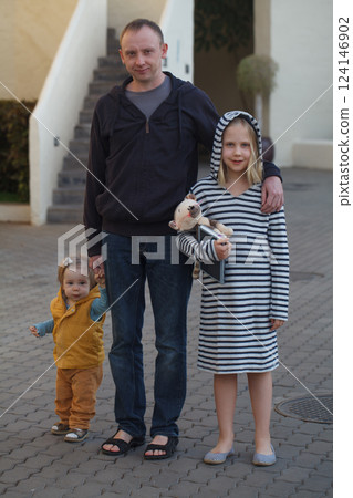 Happy father and two daughters together, portrait 124146902