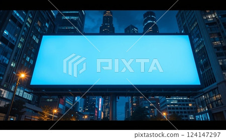 Blank Illuminated Billboard in Modern City at Night with Skyscrapers | Urban Advertising Mockup. 124147297