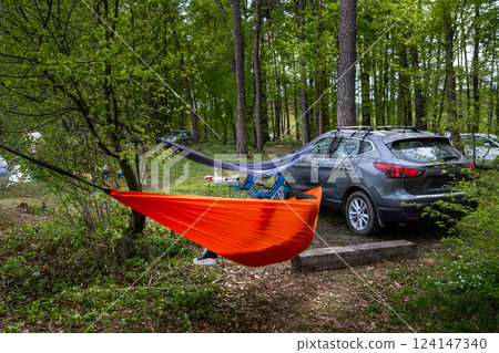 Forest Campsite with Hammocks and Car Forest Campsite with Hammocks and Car 124147340