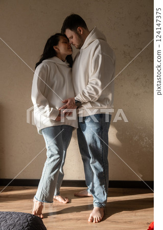 Intimate Moment of Expecting Parents by the Window Intimate Moment of Expecting Parents by the Window 124147375