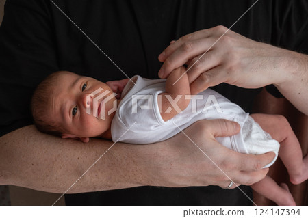 Newborn Baby Cradled in Hand 124147394