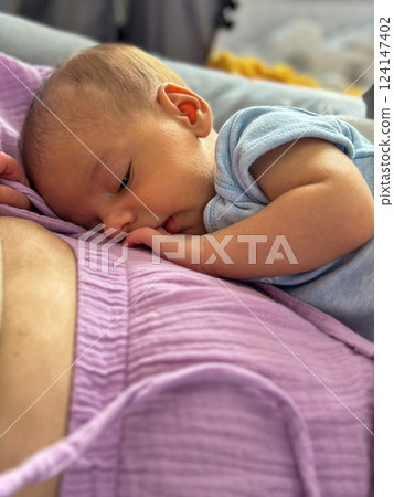 Newborn Baby Resting on mother tummy 124147402