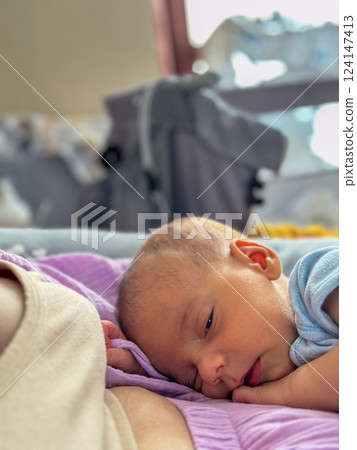 Newborn Baby Resting on mother tummy 124147413