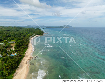 Turquoise sea water and waves. Coastline with trees and white sandy beach. Santa Fe, Tablas, Romblon. Philippines. Turquoise sea water and waves. Coastline with trees and white sandy beach. Santa Fe, Tablas, Romblon. Philippines. 124147528