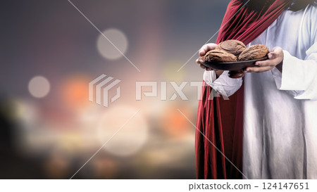 Jesus Christ holding the bread of life to feed the poor. Concept of Christianity, faith, and spirituality Jesus Christ holding the bread of life to feed the poor. Concept of Christianity, faith, and spirituality 124147651