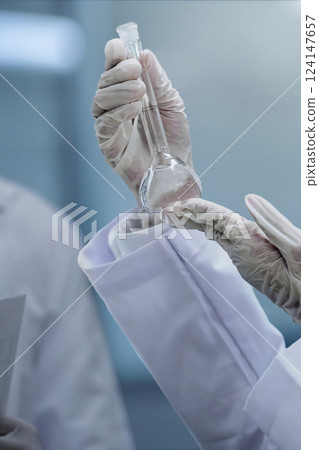 Scientist checking quality of medicine in the modern inspection laboratory in a medicine production factory 124147657