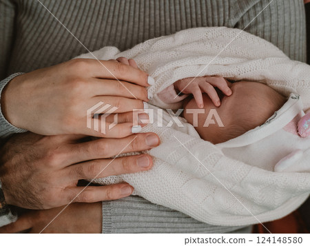 Newborn Baby Held in Parents' Loving Hands 124148580