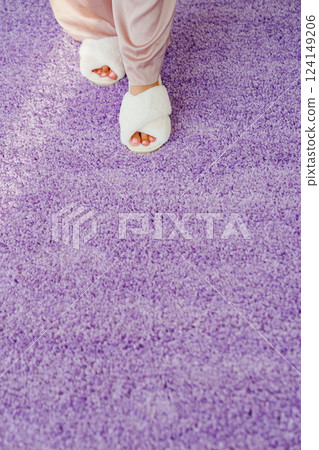 soft white slippers on the violet Interior pile carpet. 124149206