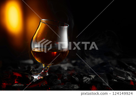Snifter of brandy on a burning charcoal. 124149924