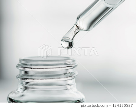 A close-up of a glass dropper with a single drop 124150587