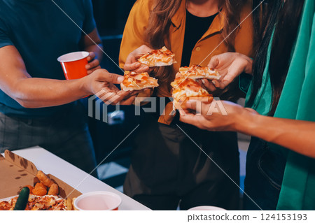 Happy young friends group having lunch at home. Asia family party eating pizza food and laughing enjoying meal while sitting at dining table together at house. Celebration holiday and togetherness. 124153193