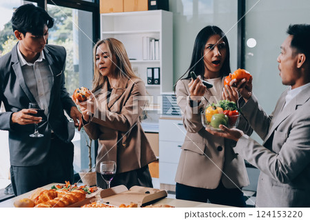 Asian office colleagues and friends enjoy a daytime BBQ with pizza and beer, celebrating Halloween and cheering for their favorite soccer team, creating a lively atmosphere filled with joy. Asian office colleagues and friends enjoy a daytime BBQ with pizza and beer, celebrating Halloween and cheering for their favorite soccer team, creating a lively atmosphere filled with joy. 124153220