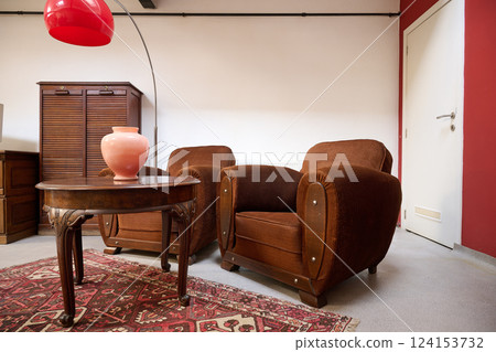 Loft with old fashionned table and sofa against white wall 124153732