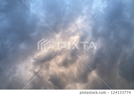 Cloudy sky, sunlight shining through rain clouds 124153774